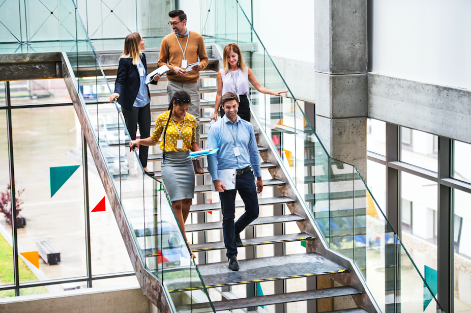 business people going down stair in an office